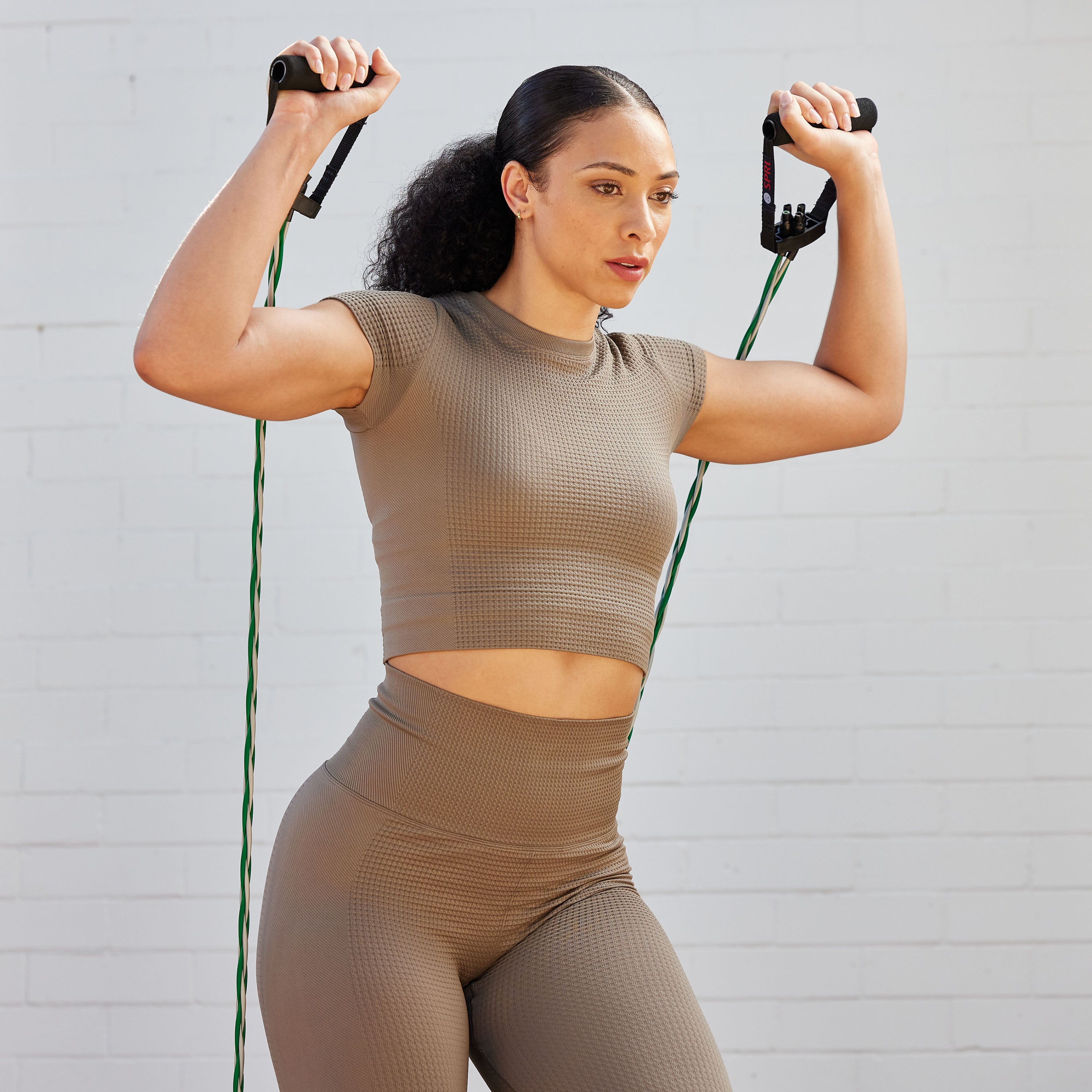 Person doing an over head press with the Braided Xertube